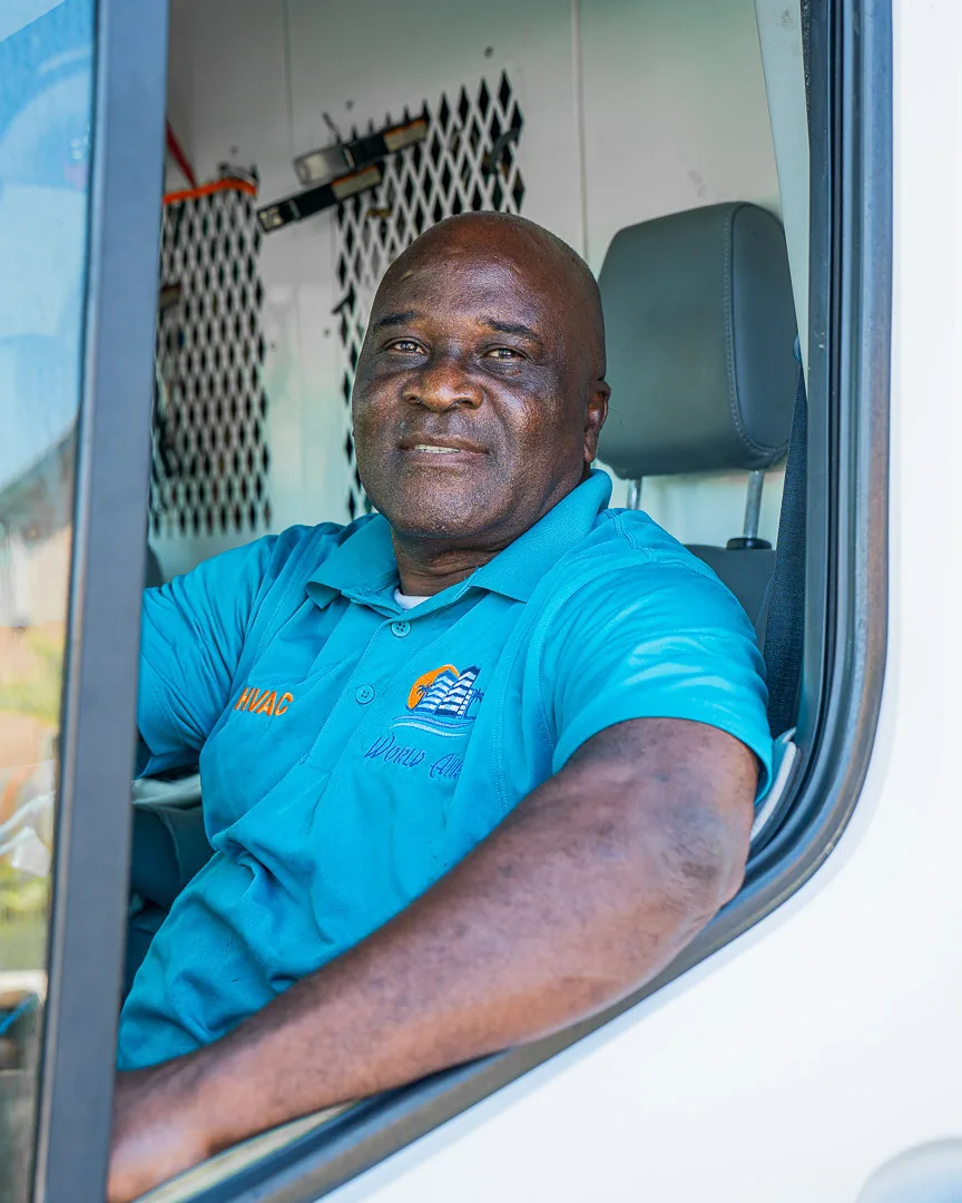 World Air HVAC owner smiling in service vehicle — family-owned company