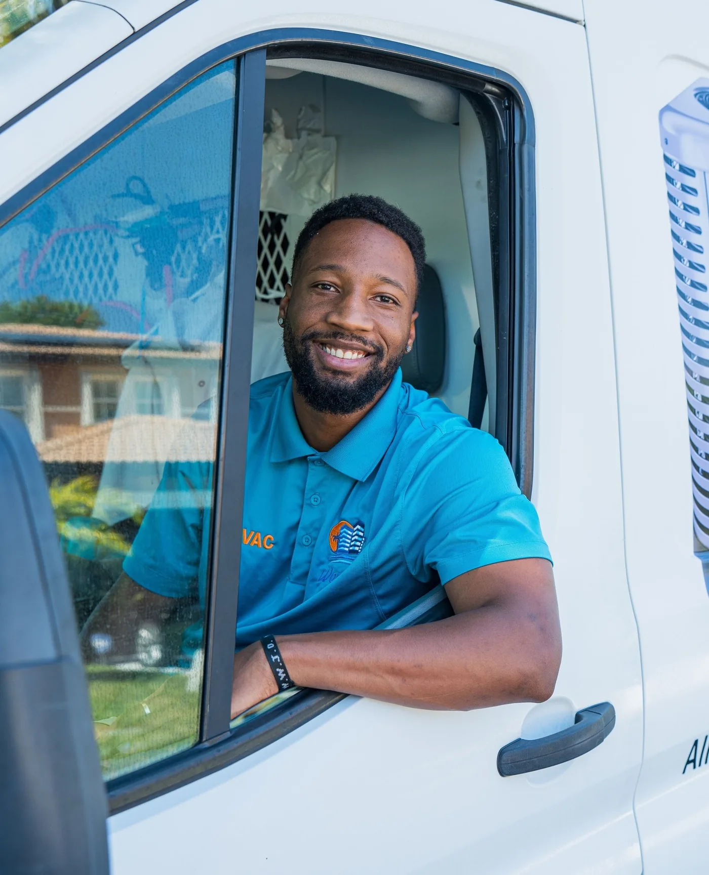 World Air HVAC team standing with branded company van — Installation, Repair, Maintenance